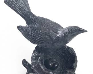 Small Bronze Bird Protecting Nest of Eggs