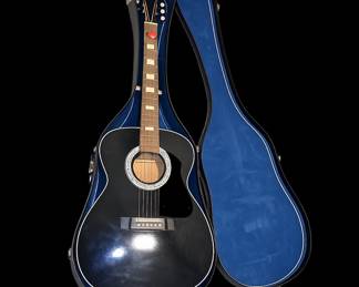 Black guitar in blue velvet case