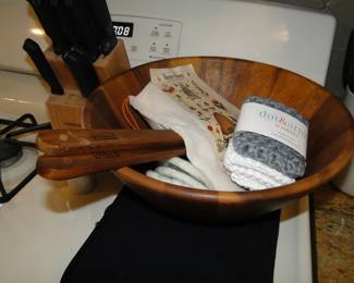 Teak salad bowl with serving utensils, and some kitchen towels too