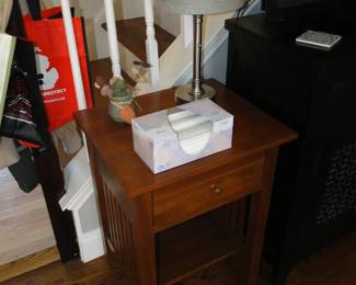 A tissue box, on a nice mission style wooden table. In case you need a tissue.