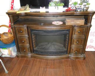 The next piece of magical furniture is this fireplace, mantle, storage combination