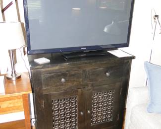 Flat screen TV, and a very nice hutch