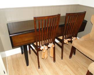 The second magic piece of furniture is this dining room or kitchen table. Or fold it down and make it a sofa table