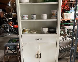 Metal cabinet. Lots of plant pots.