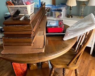 Table has several leaves, two armchairs and two armless chairs 