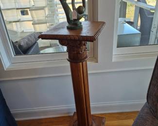 Carved oak pedestal with soapstone statue