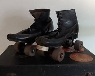 Pair of vintage roller skates in case