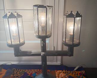 vintage-style electric candelabra table lamp featuring three glass-paned lantern shade