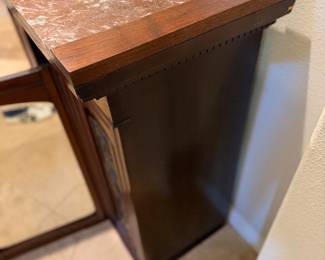 antique wooden fireplace mantel featuring a reddish-brown marble top and a centered mirror