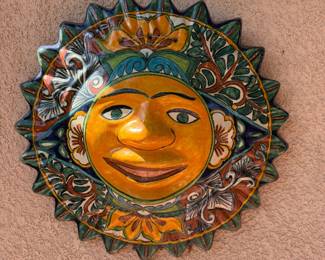colorful sun face is a piece of Mexican Talavera pottery