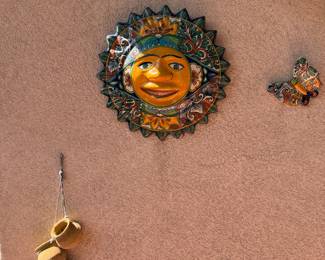 colorful sun face is a piece of Mexican Talavera pottery