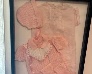 Framed vintage baby clothes 
