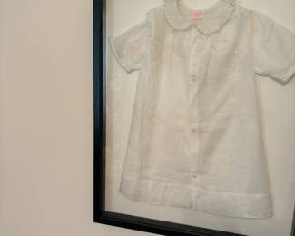 Framed vintage baby clothes 