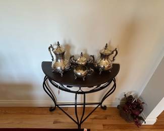 Table with silverplate , coffee tea set.