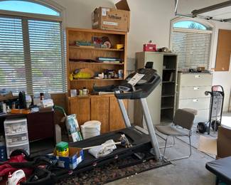 Treadmill, file cabinets, cabinetry, desk