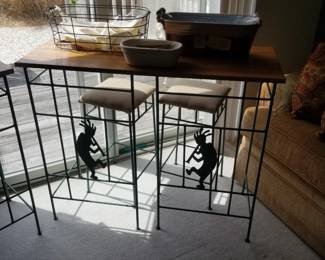 High top dining set with Kokopelli figures in bases of bar stools
