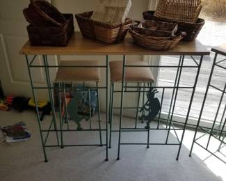 High top dining set with Kokopelli figures in bases of bar stools