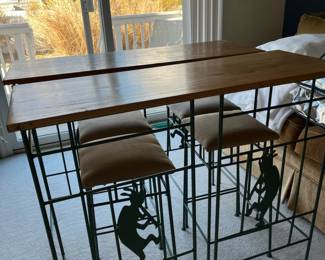 High top dining set with Kokopelli figures in bases of bar stools