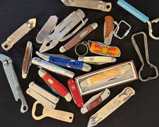 Collection of antique and vintage folding pocket knives and multi-tools.