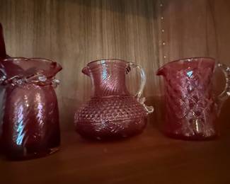 Set of Three Amethyst Glass Pitchers: Hobnail, Diamond Cut, and Ribbed