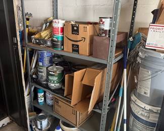Assorted Paint Cans, Household Supplies, and Metal Shelving Unit