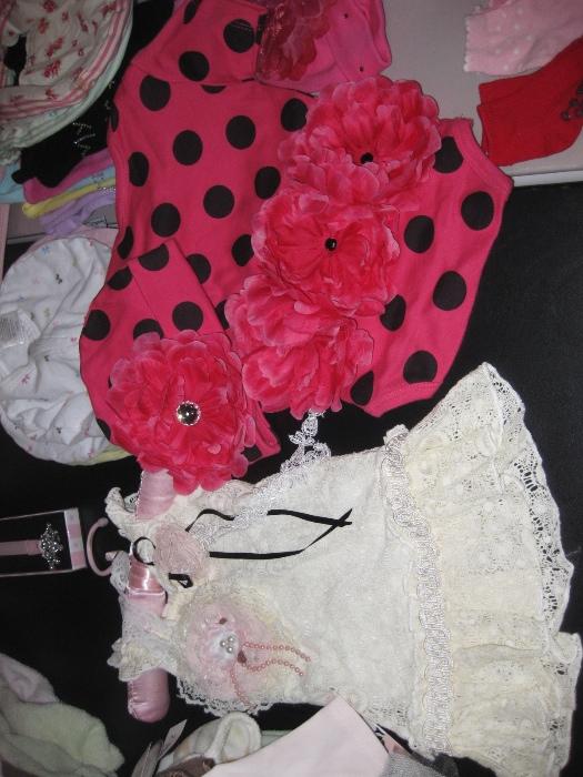 tons of precious baby clothes....some not ever worn