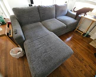 Pull out couch with storage under chaise, custom foldable side table, and side table with plug in
