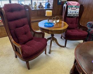 traditional wingback lounge chairs with: 	•	Cane side panels 	•	Wood frame 	•	Tufted cushions 	•	Burgundy upholstery