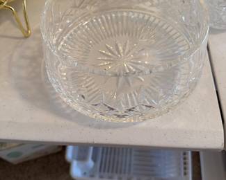 Elegant clear cut glass serving bowl featuring a classic starburst base pattern with decorative faceted sides. Thick glass construction with detailed geometric cuts