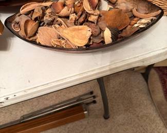 Oval decorative bowl filled with assorted dried potpourri botanicals including seed pods, shells, and natural dried plant pieces. Warm brown tones with rustic natural textures. Great as a decorative centerpiece, coffee table accent, or shelf décor.