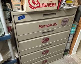 Simplicity pattern cabinet filled with numerous sewing patterns