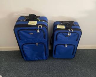 R82 - $15. Pair of Blue Rolling Luggage.