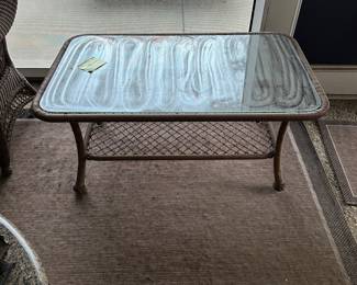 R12 - $50. Plastic Rattan Glass Top Coffee Table in very good condition! Measures 43.5" x 26" x 19.5".