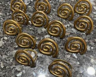 R84 - $25. Set of 14 Brass Spiral Napkin Rings.