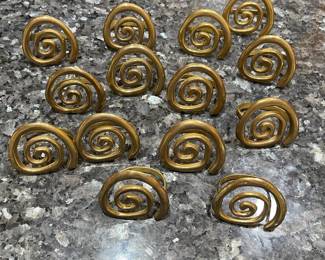 R84 - $25. Set of 14 Brass Spiral Napkin Rings.