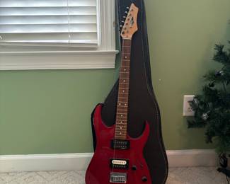 R32 - $30. Jackson Electric Guitar. I don't see a model # and there is damage where the strap is attached.