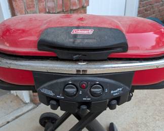 R55 - $125. Coleman RoadTrip Propane Grill on Folding Stand.