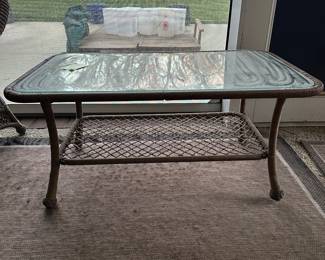 R12 - $50. Plastic Rattan Glass Top Coffee Table in very good condition! Measures 43.5" x 26" x 19.5".