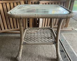 R14 - $30. Square side table. Plastic Rattan with glass top. Measures 21.75" square x 19.75" tall.