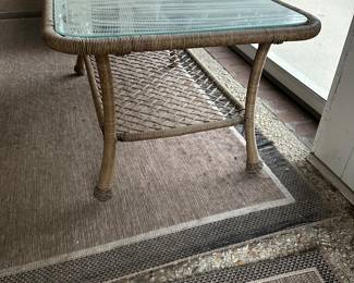 R12 - $50. Plastic Rattan Glass Top Coffee Table in very good condition! Measures 43.5" x 26" x 19.5".