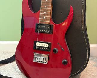 R32 - $30. Jackson Electric Guitar. I don't see a model # and there is damage where the strap is attached.