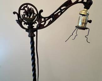 C25 - $40. Iron Floor Lamp. Probably needs rewired. Measures 56.5" tall. Has ship design on the top arm. 