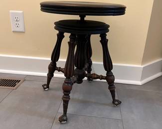C10 - $65. Piano Stool with glass feet. Adjustable height. Seat Measures 14.75” wide x 19” tall all the way down. Seat is 2 layers and needs glued back together. 