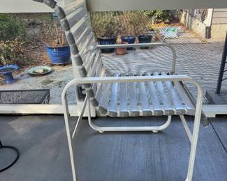 C28 - $350. Woodard Furniture Glass Top Table & 4 Vinyl Strap Chairs. Measures 47.5" round x 28" tall. Chairs are 23.5" x 25.5" x 36" tall. Has been used on a screened in porch - a few very minor rust spots
