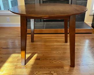 C15 - $75. Kitchen Table with small drop leaves. Leaves down it measures 42.25” wide x 30” deep 30.5” tall. Each leaf adds 7.25". 