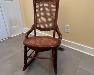 C5 - $40. Single Caned Antique Childs Rocking Chair (from the mid 1800s). Seat is in very good condition - Back has holes. Measures 19” wide x 29.25”deep x 34.25” tall 
