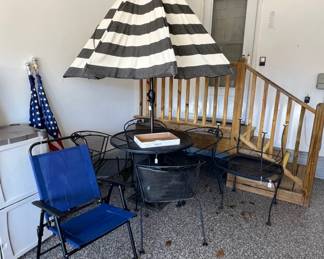 nice heavy iron table, chairs, umbrella