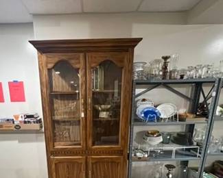 Wood china cupboard, candle holders, glass plates, dishes