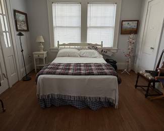 Vintage Wooden Bed Frame with Plaid Bed Skirt and Tiki Bar Sign
