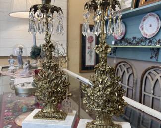 Antique Rococo Revival Style Girandole Candlesticks crafted from brass with hanging crystal prisms and white marble bases 